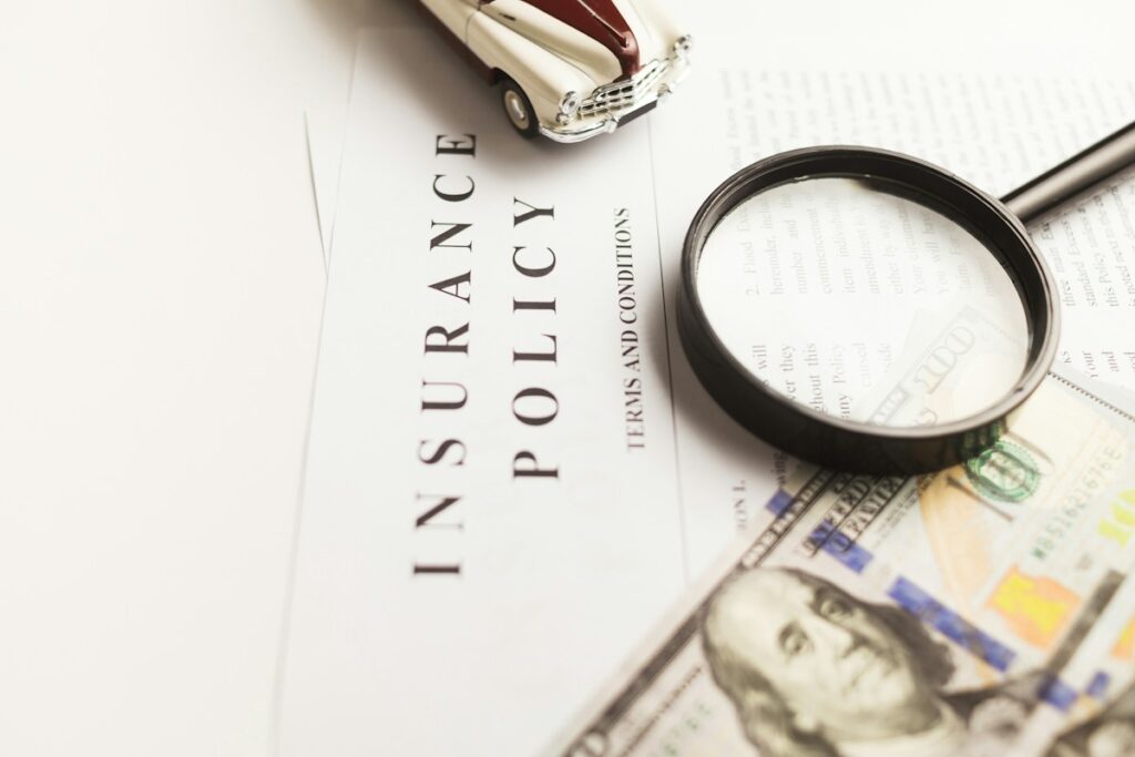 Texas Insurance Nonrenewal: Your Right to a Written Reason 1 Car insurance paperwork being checked with a magnifying glass