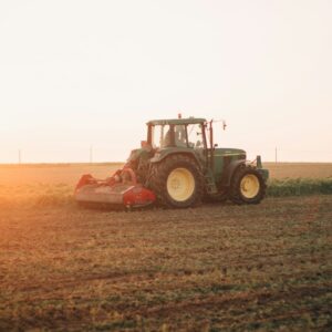 Red tractor working in a farm field