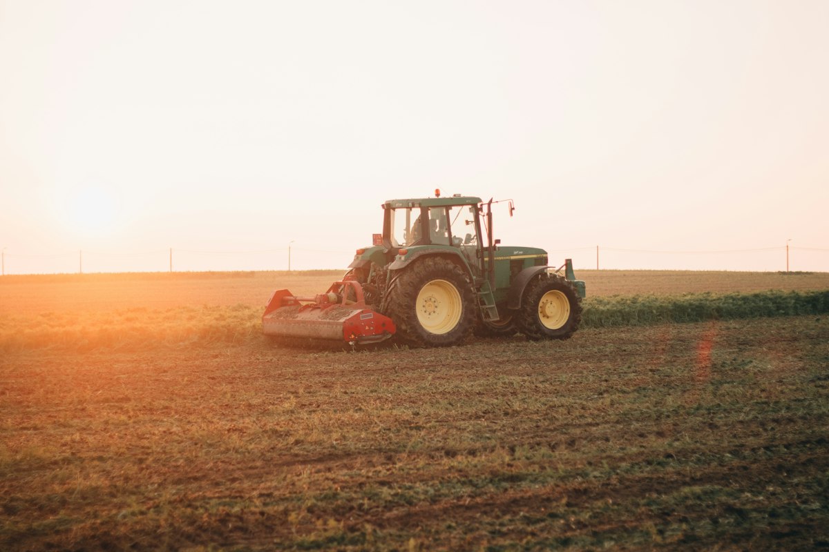 Farm Equipment Scams: How to Verify a Tractor Dealer Before Wiring Money 1 Red tractor working in a farm field